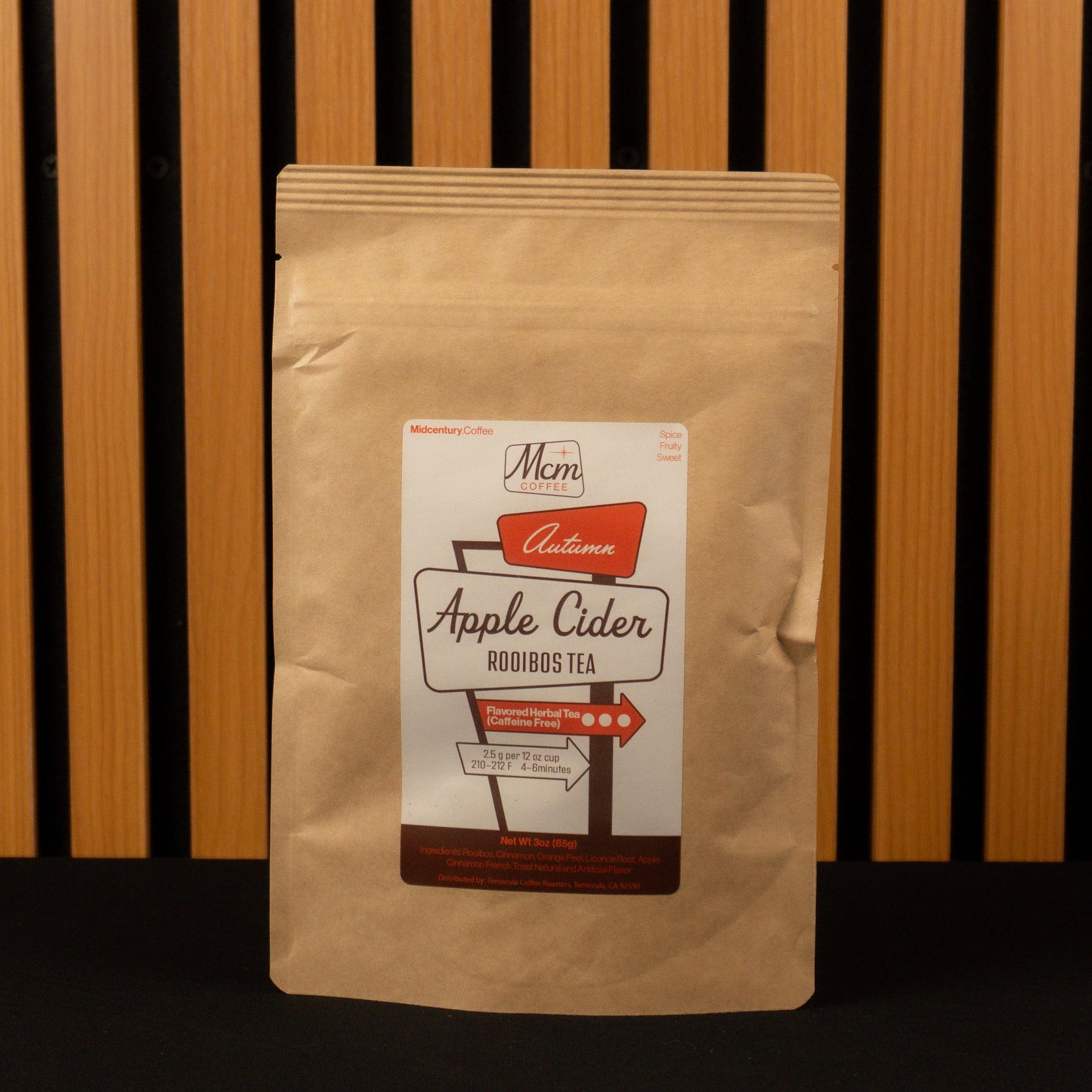 Kraft paper tea bag with a label on a wooden background Apple Cider Rooibos Tea