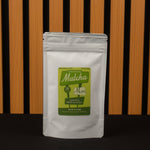 Matcha green tea package with a green label on a wooden background