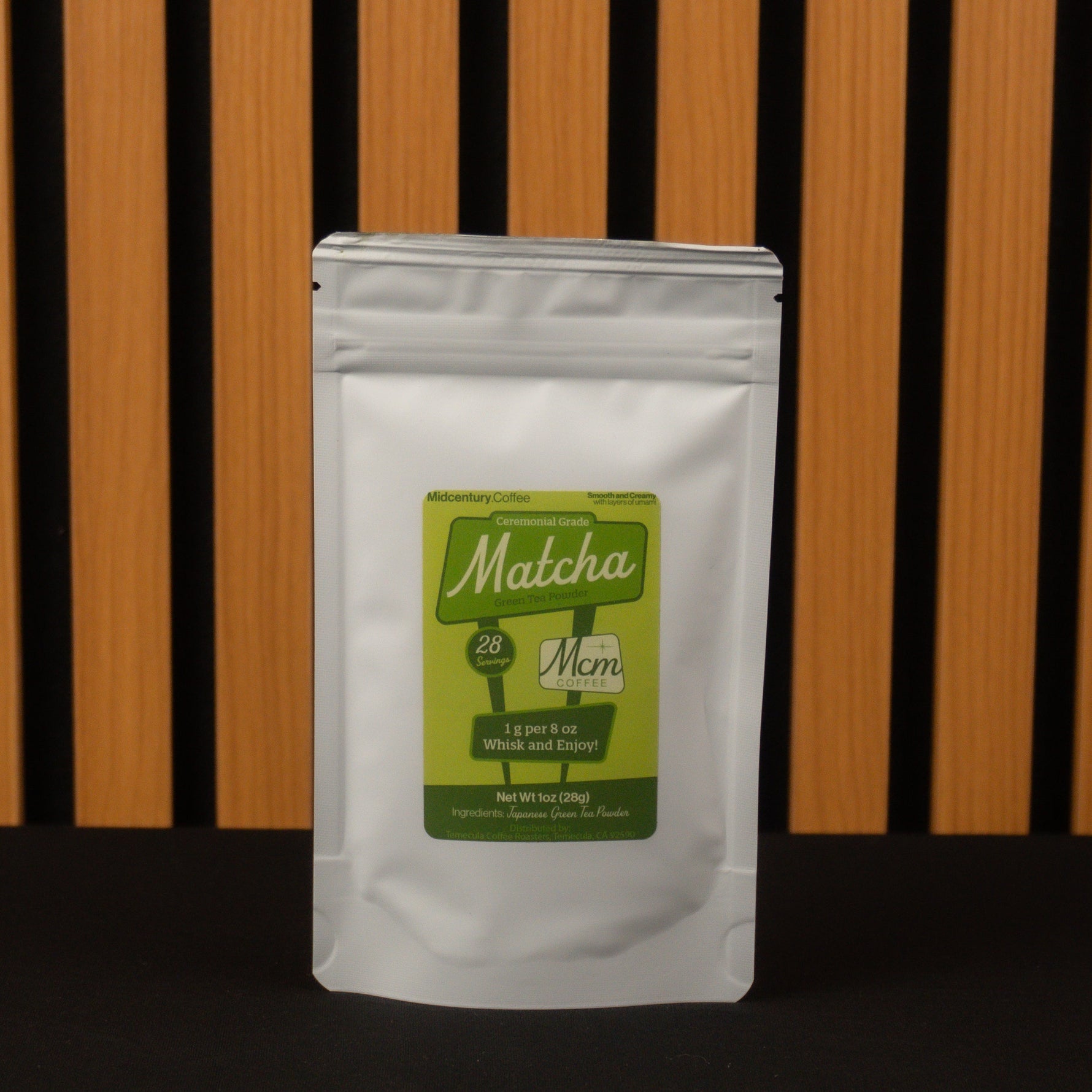 Matcha green tea package with a green label on a wooden background