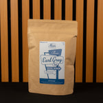 Kraft paper Classic Earl Grey Tea bag with a label on a wooden background