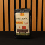Coffee bag labeled 'Credenza Sumatra' on a wooden background