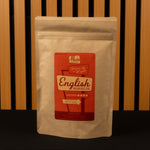 Tea package with a red label on a wooden background