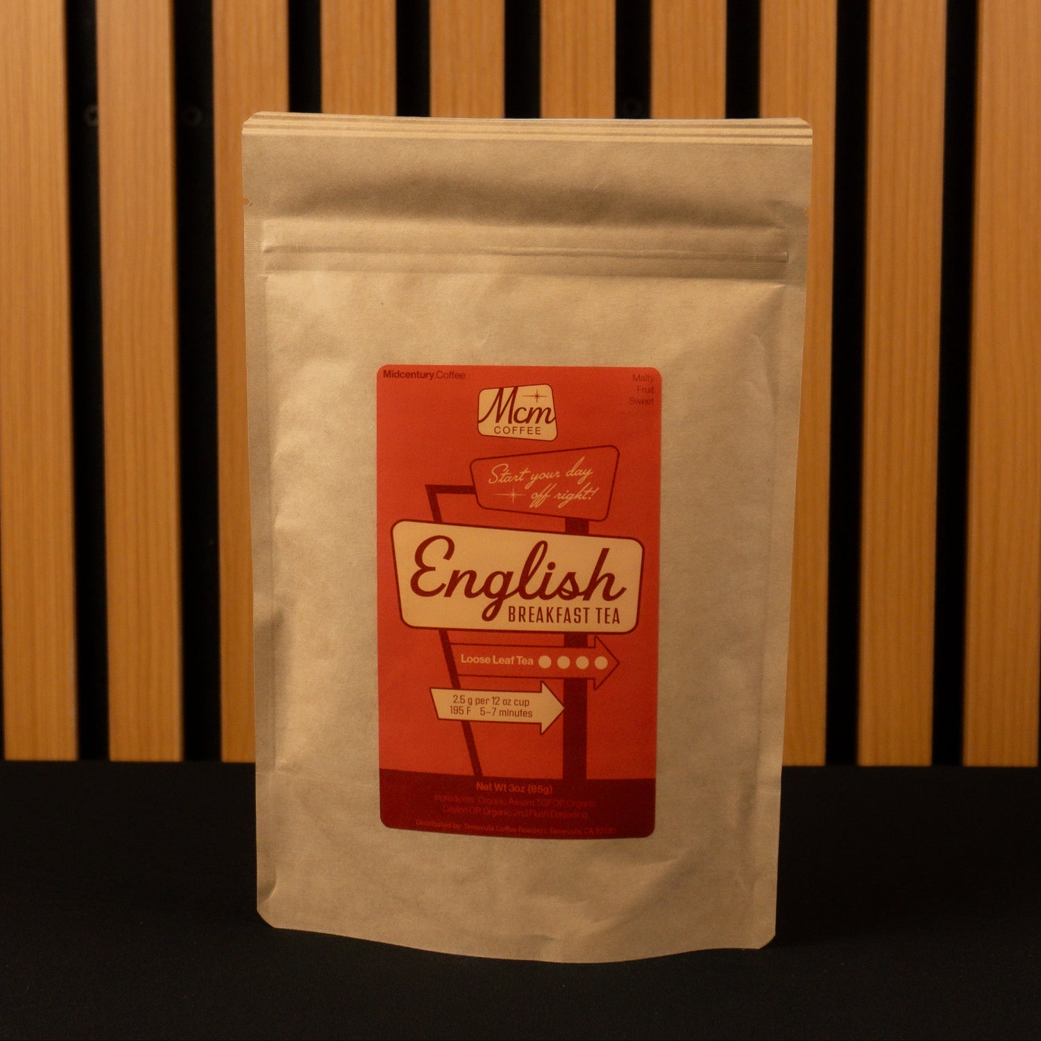 Tea package with a red label on a wooden background